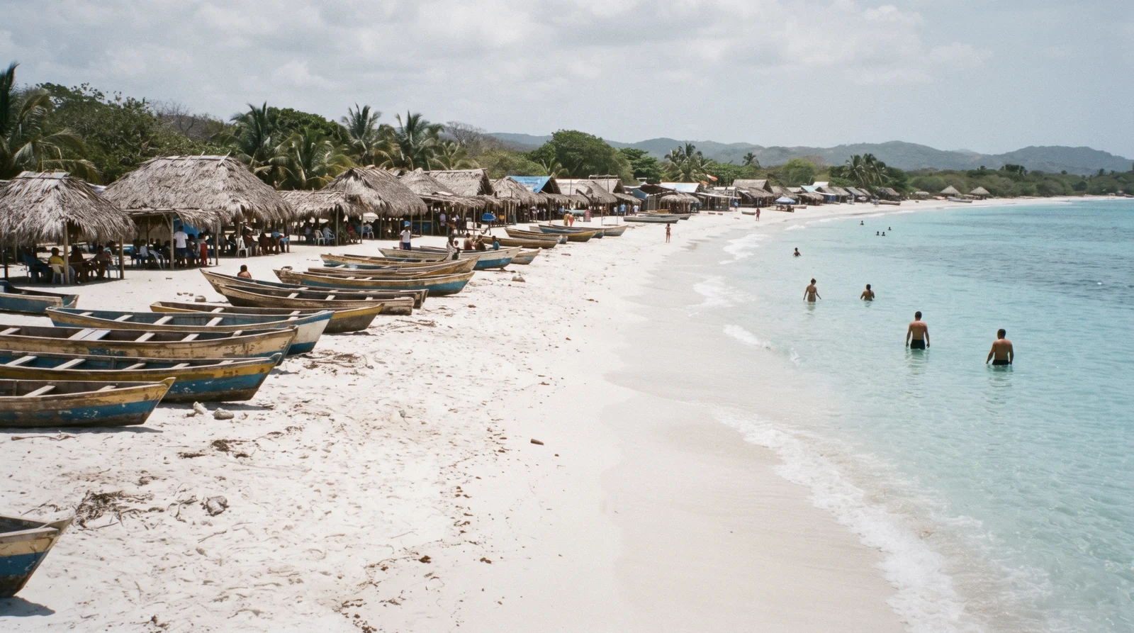 Thatched-roof beach shacks and hammocks along the white sand of Playa Blanca on Isla Barú near Cartagena