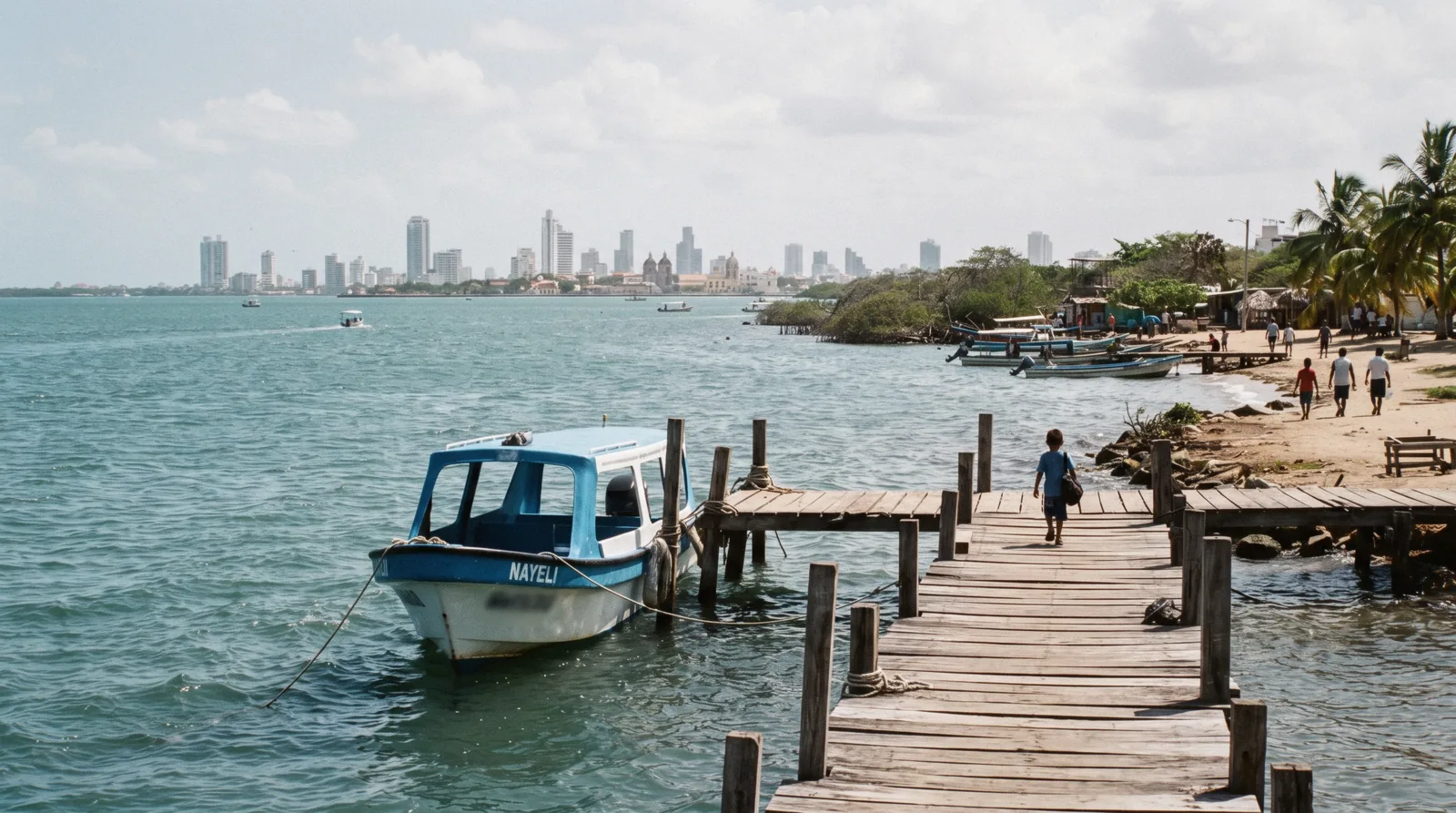 The Tierra Bomba shoreline facing Cartagena's bay, with a passenger boat approaching the island