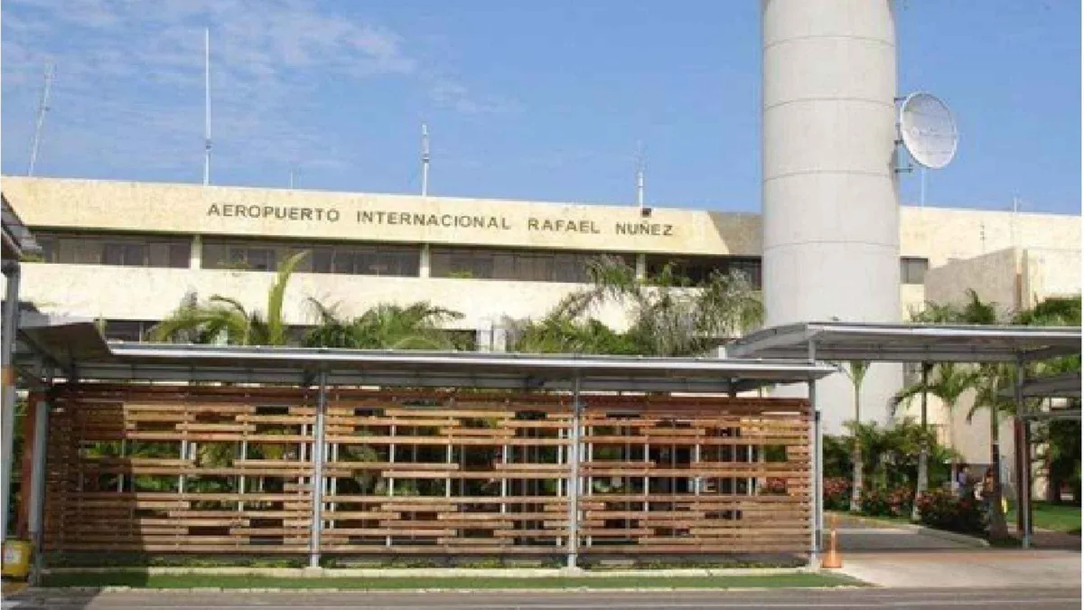 A driver holding a name sign at Rafael Nunez Airport arrivals for a private Cartagena transfer, Colombia