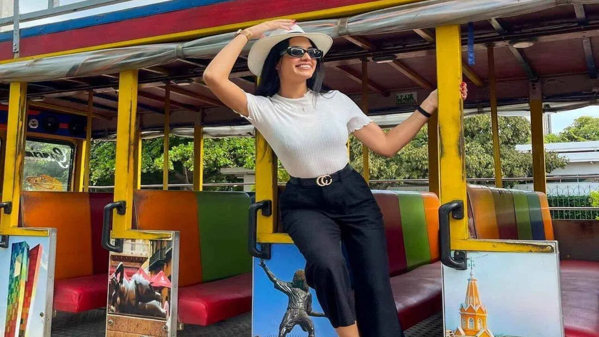 A colorful traditional chiva bus parked at a photo stop overlooking Cartagena, Colombia