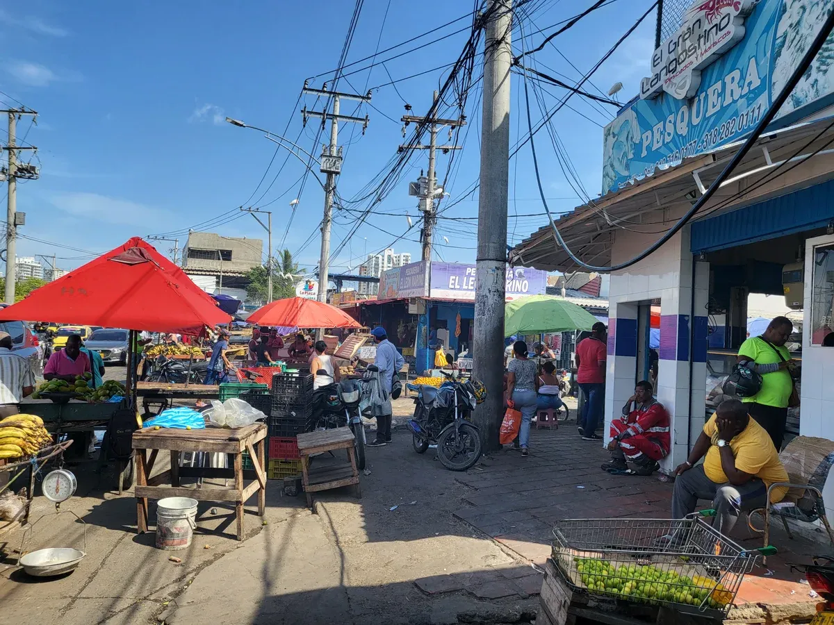 Stalls and produce crates in the covered aisles of Bazurto market on a Cartagena, Colombia city guide