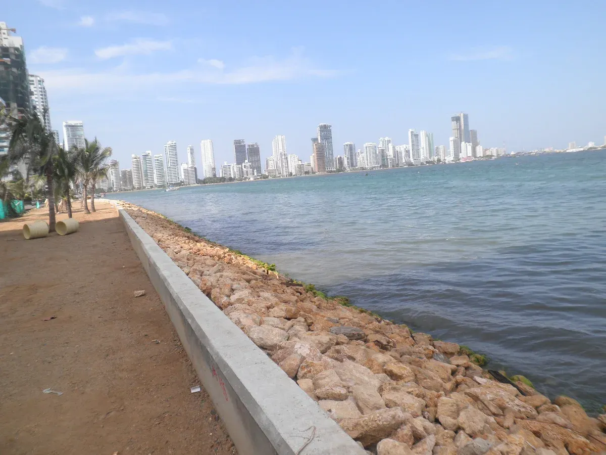High-rise Bocagrande hotel towers behind a rock revetment holding back the surf in Cartagena, Colombia