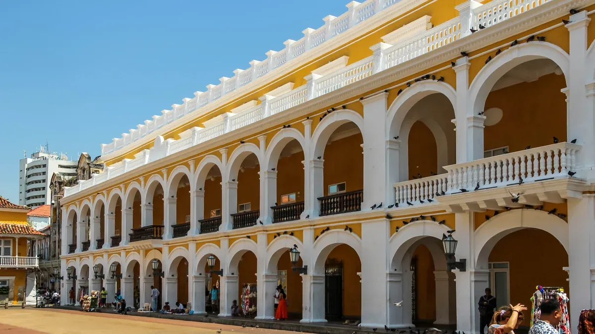 The arcaded colonial palace on Plaza de la Aduana where independence was proclaimed, on a Cartagena, Colombia city guide