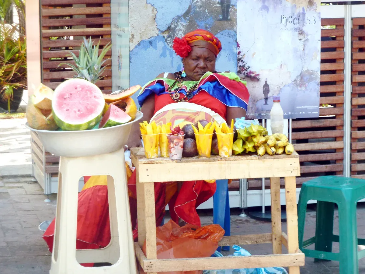 A palenquera at her fruit stall on Plaza de San Pedro Claver on a Cartagena, Colombia city guide